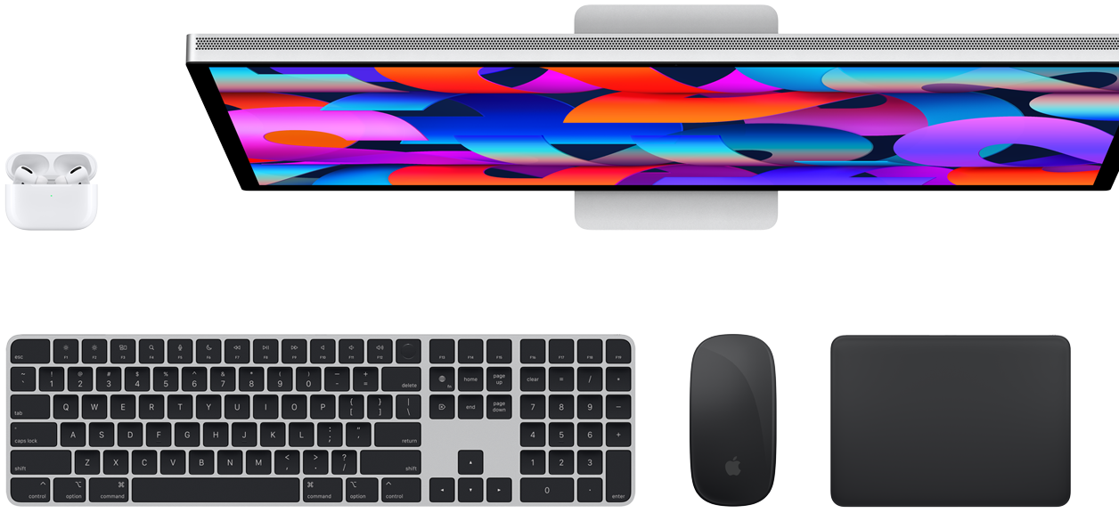 Widok z góry na AirPods, monitor Studio Display, klawiaturę Magic Keyboard, mysz Magic Mouse i gładzik Magic Trackpad